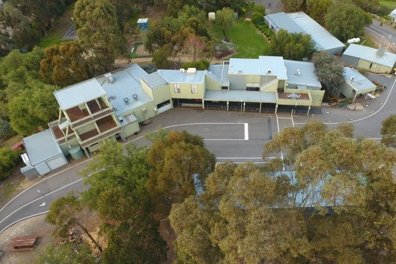 camp buildings surrounded by bush