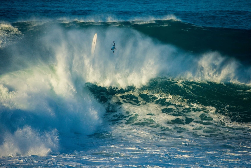 Damien Hobgood ejecting over the back of a huge wave