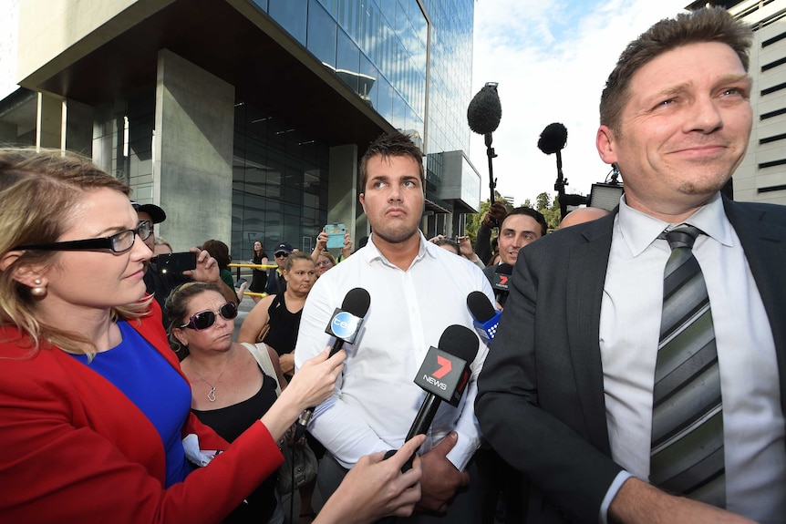 Lawyer Nick Dore (right) smiles as Gable Tostee (centre)