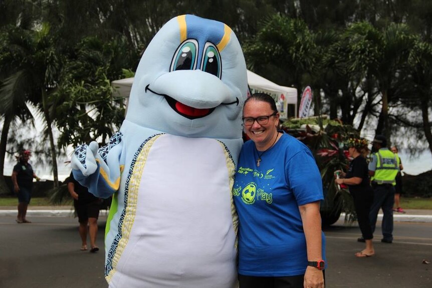 Michelle Paiti with the Just Play mascot, a dolphin