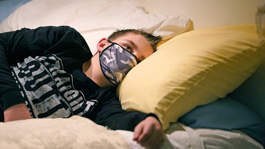 Cooper Wuthrich rests as he lays on a bed at the truck stop his family partly owns.