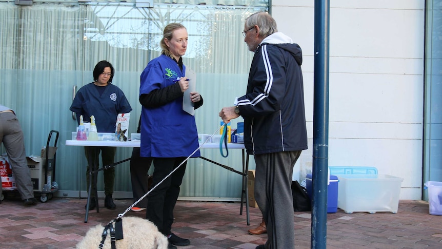 John and 17-year-old poodle-cross Shampers at a free vet clinic.