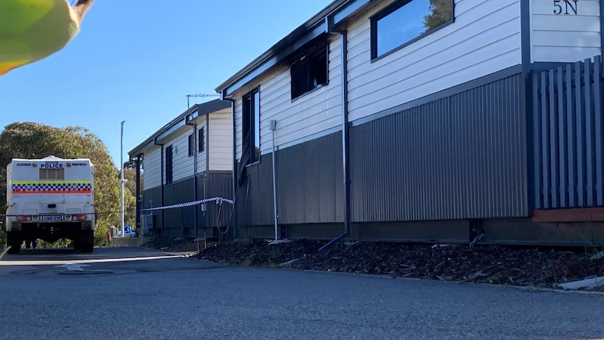 A police wagon, smoke damage is visible near the cabin window, there are two cabins.