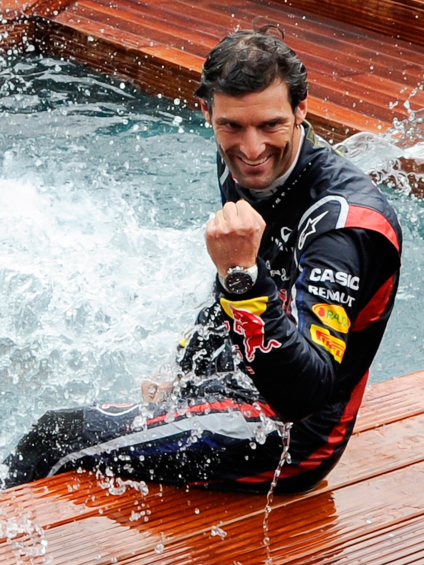 Mark Webber dives in the team pool after winning in Monaco.
