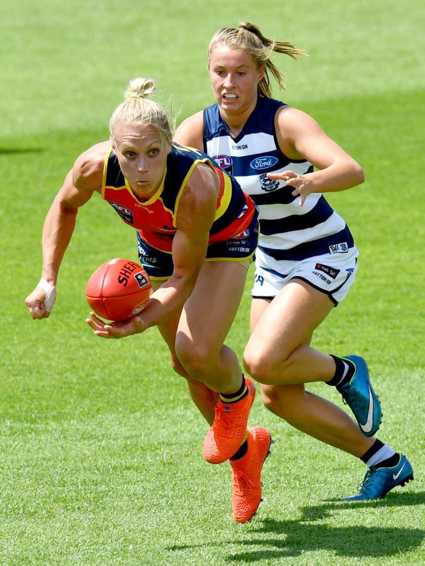 Erin Phillips of the Adelaide Crows handballs against Geelong.