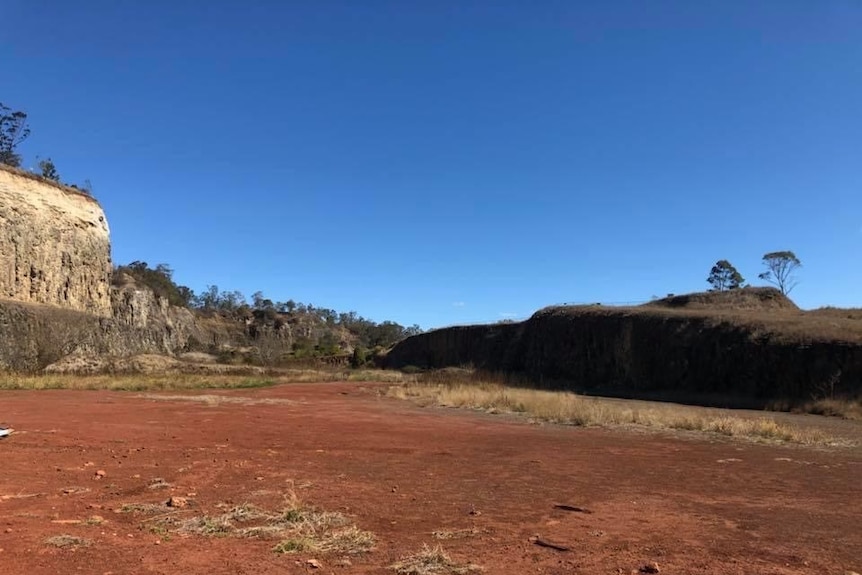 A large flat area flanked by quarry walls at the former site of the Bridge Street Quarry, Toowoomba, August 2020.