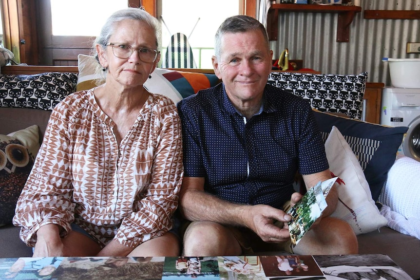 Gary Devitt and his wife Mischelle look through photos at their home in New Farm in Brisbane.