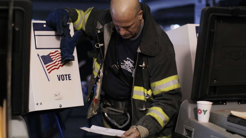 A firefighter votes in Queens