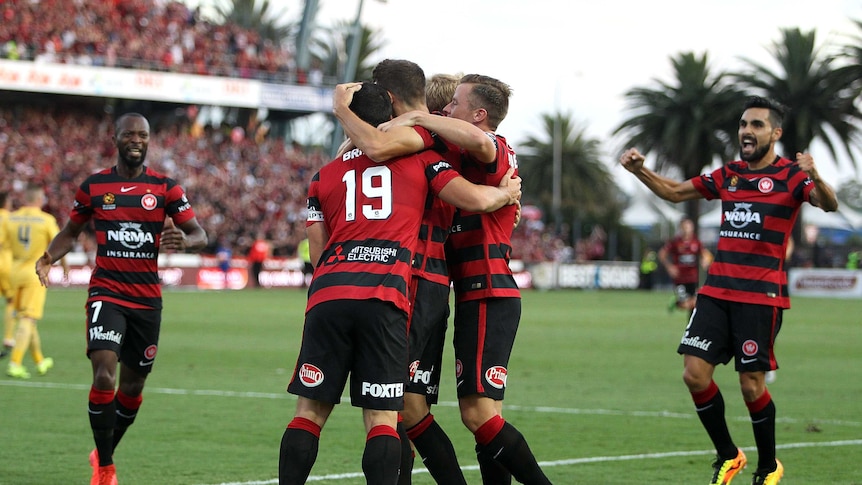 Wanderers players celebrate a goal against Central Coast at Gosford on January 23, 2016.