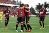 Wanderers players celebrate a goal against Central Coast at Gosford on January 23, 2016.