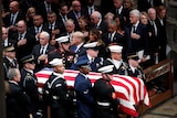 Pallbearers carry the flag-draped casket of former US President George HW Bush.