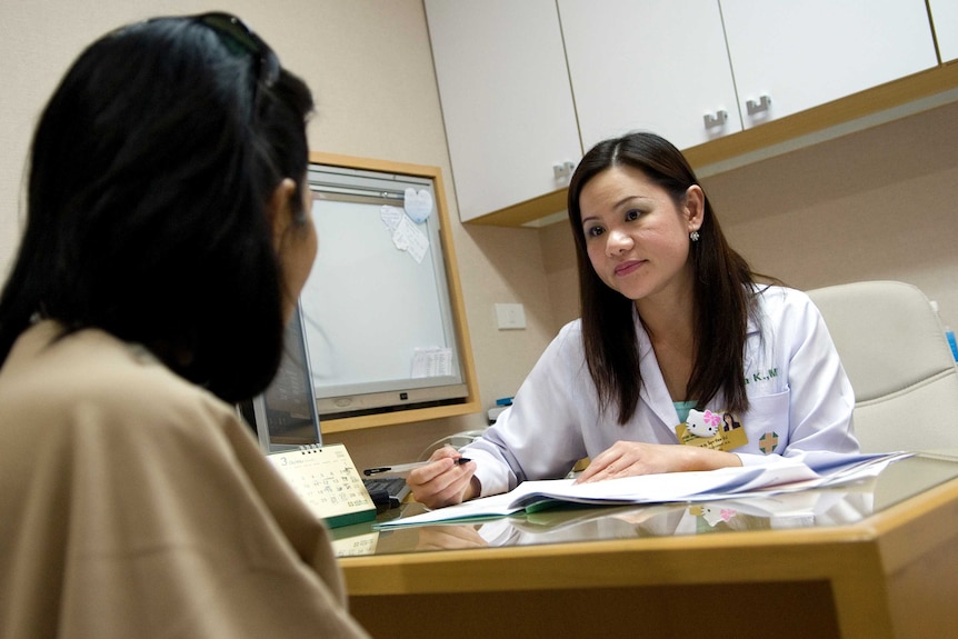 A doctor consults with a patient