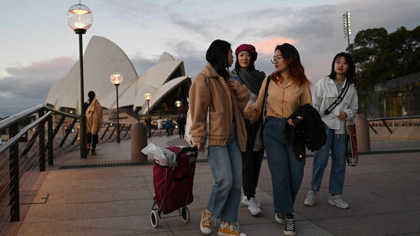 Four female Chinese international students in front of Sydney Opera House.