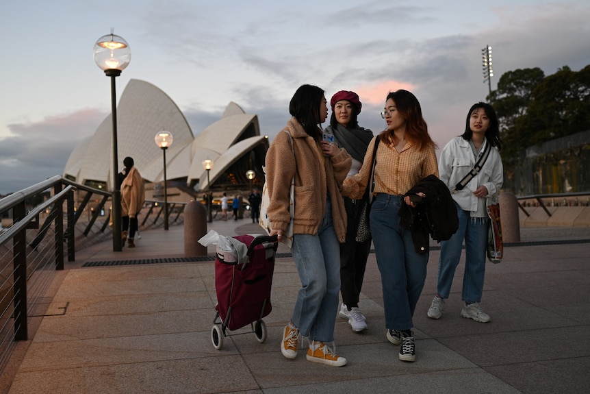 Four female Chinese international students in front of Sydney Opera House.