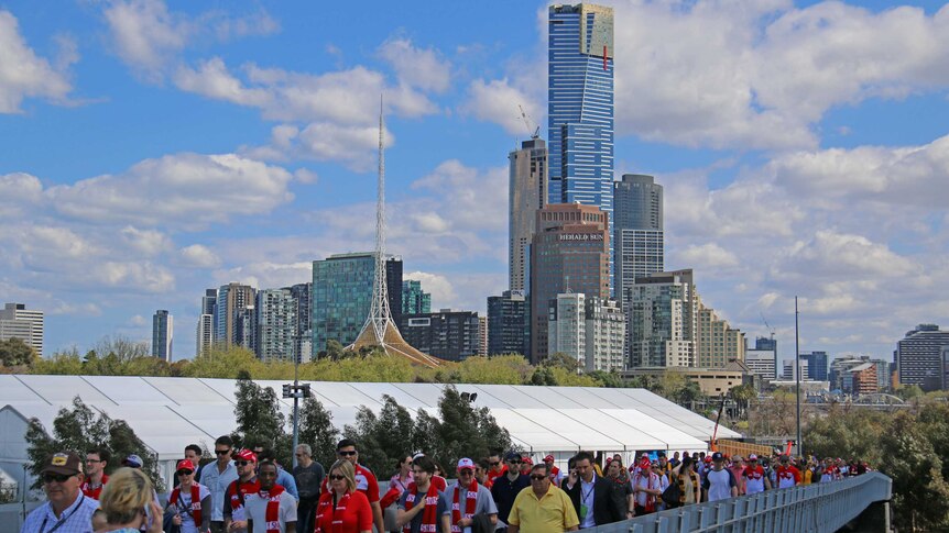 Crowds pour into the MCG for the AFL grand final.
