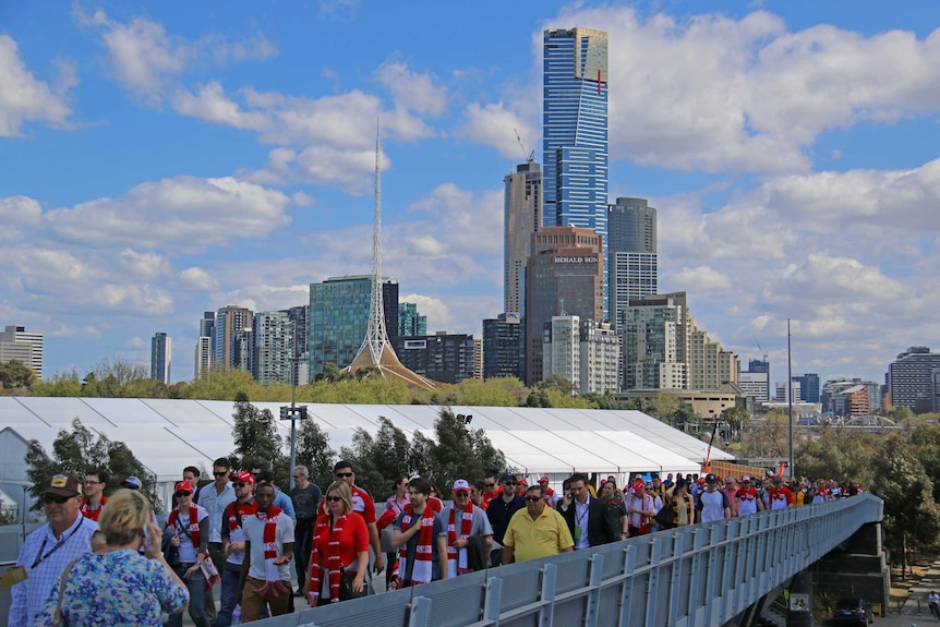 Crowds pour into the MCG for the AFL grand final.