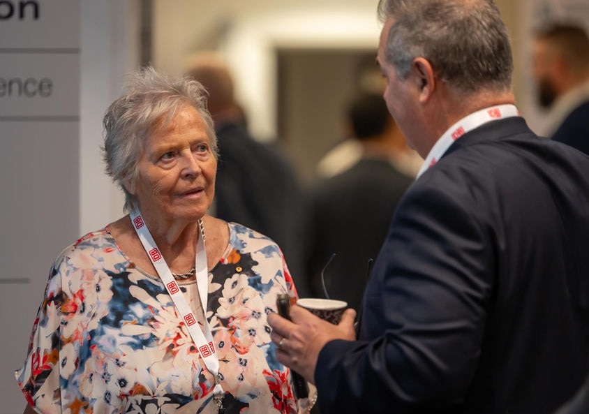 Woman talking to a man at a conference