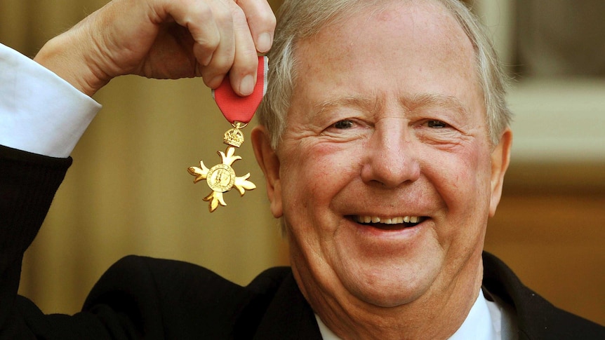 Tim Brooke-Taylor holds his OBE after being presented it by Queen Elizabeth, outside Buckingham Palace in 2011.