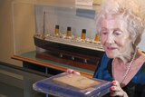 Joy Lester looks at her mother's address book. The book is on display at Brisbane's Queensland Maritime Museum.
