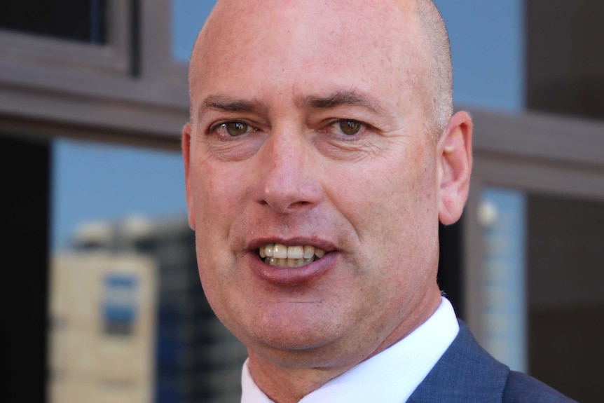 A tight head and shoulders shot of WA's Shadow Treasurer Dean Nalder speaking outside State Parliament.