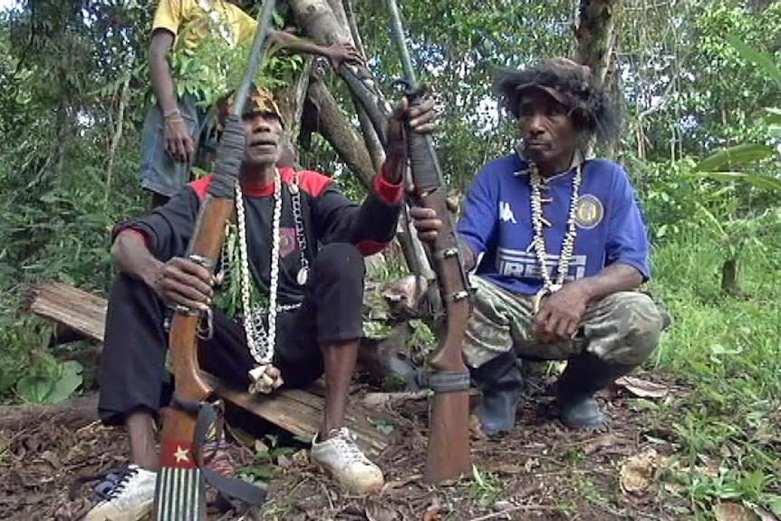 Papuan rebels display their weapons