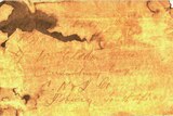 A scanned image of a water-damaged piece of paper with a faded hand-written note.