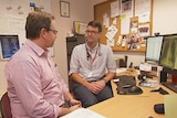 Dr Bastian Seidel talks to a patient