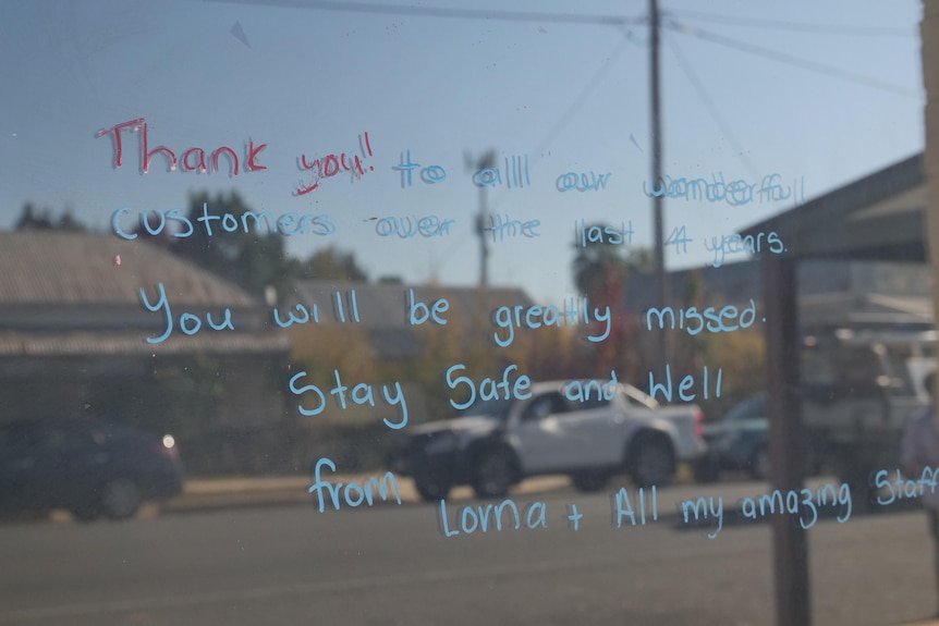 A thank you message written on a glass door. 