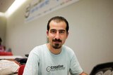 Bassel Khatabil Safadi, dressed in a creative commoner t-shirt, poses for a portrait