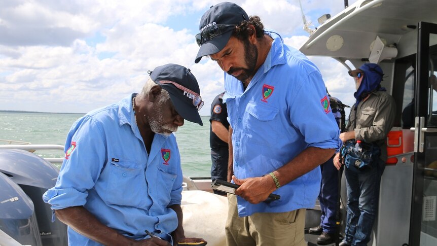 Thamarrurr rangers Boniface Nemarluk and Uriah Crocombe take notes during the training course on Darwin Harbour