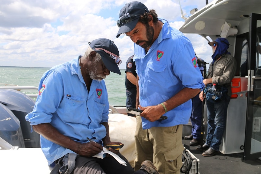 Thamarrurr rangers Boniface Nemarluk and Uriah Crocombe take notes during the training course on Darwin Harbour