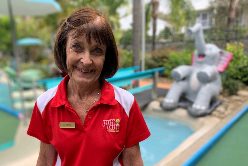 a woman standing in a mini golf course