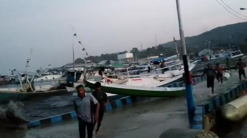 Fishermen flee inland as tsunami hits Indonesian coastline
