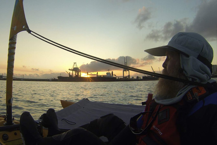 The sun rises over the port of Townsvile as ocean kayaker Malcolm Skelton begins his 456 kilometre voyage to Cairns.