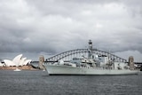 The HMS Sutherland is seen in Sydney Harbour next to the Sydney Opera House.