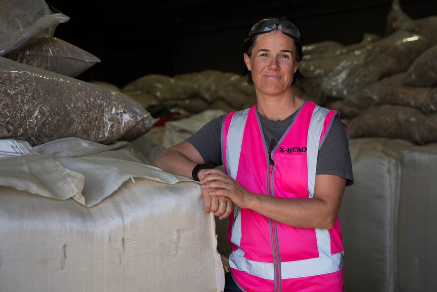 Portrait of a lady in a pink high-vis vest looking at the camera.