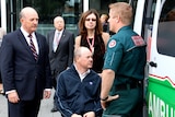 WA Health Minister John Day pictured with researcher, quadriplegic and paramedic next to ambulance