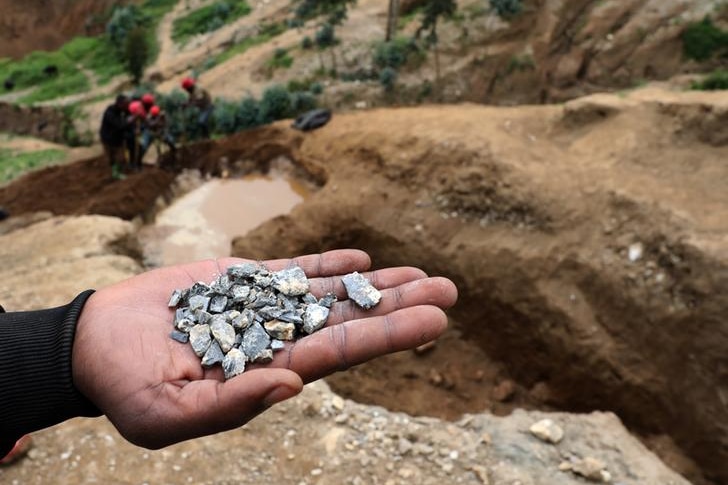 A hand spread out showing with small blue-grey stones