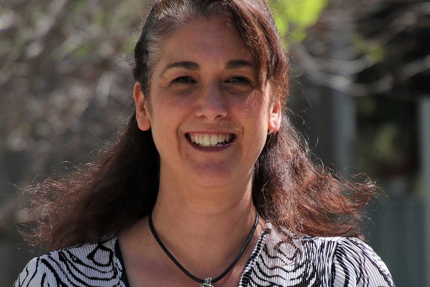 Natalie Blewitt standing outside wearing a black and white top.