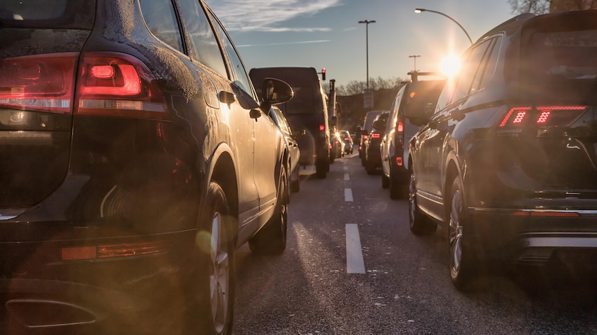 Cars wait in bumper to bumper morning traffic on a busy road