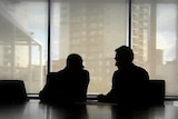 Silhouette of unidentified financial planner with client