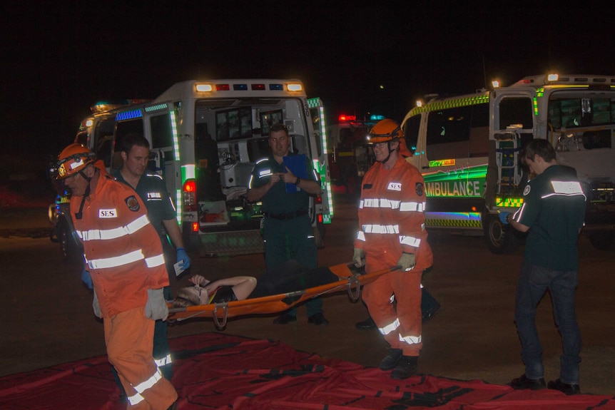 SES volunteers help move one of the "wounded" during this week's exercise.