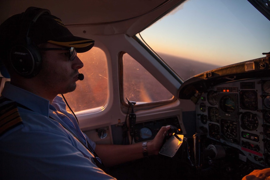 A pilot flies a plane chartered by the AEC over the Ngaanyatjarra Lands, WA.