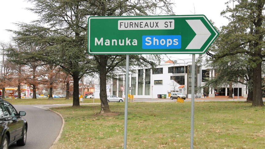 A sign directs motorists to the Manuka shops in Griffith.