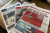 Local newspapers laid on on a table.