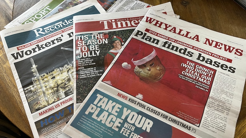 Local newspapers laid on on a table.