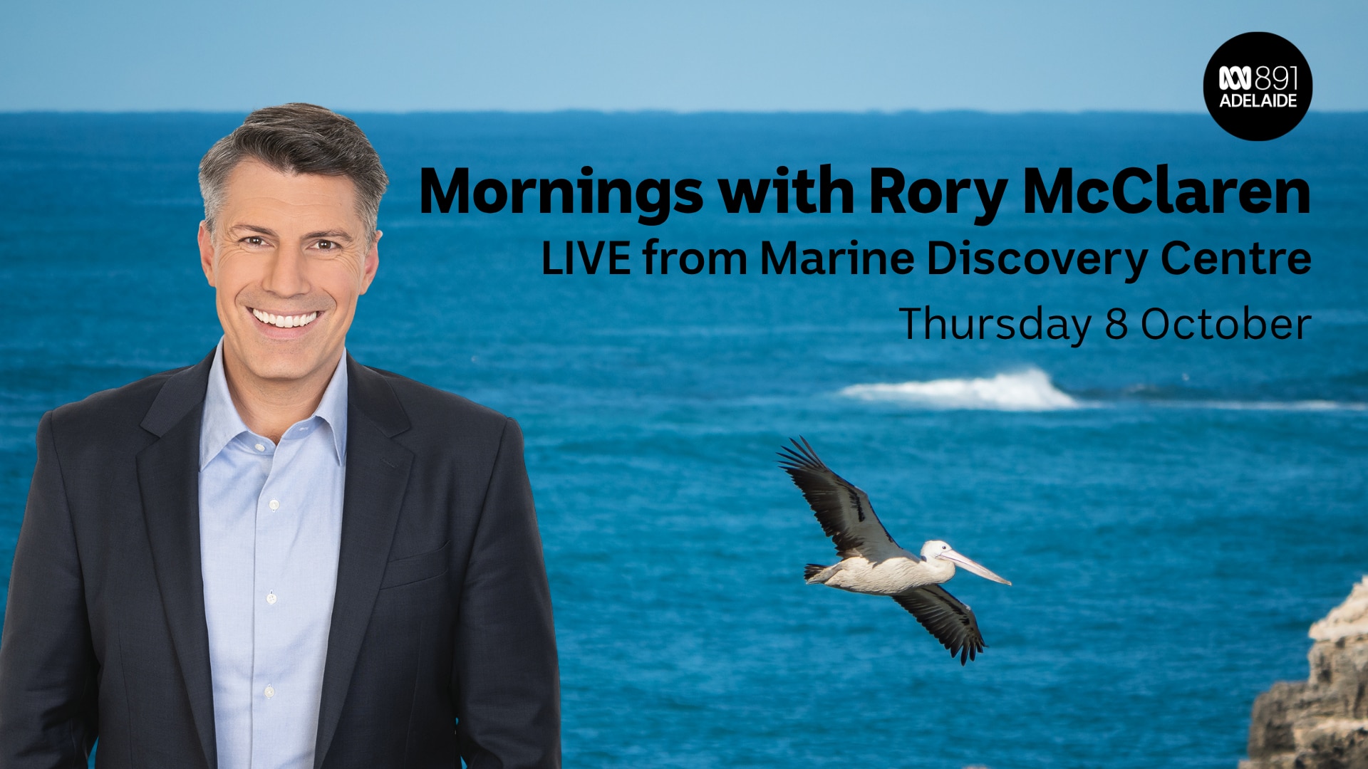Male with ocean and flying pelican behind him