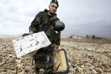 Soldier carries parts of the crashed Ethiopian Airlines plane