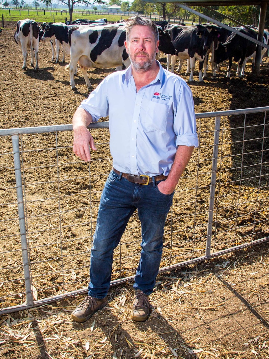 Simon Turpin leans on a farm gate.