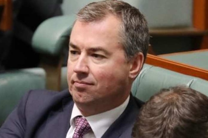 Michael Keenan flexes his fingers as he sits on the frontbench in the House of Representatives